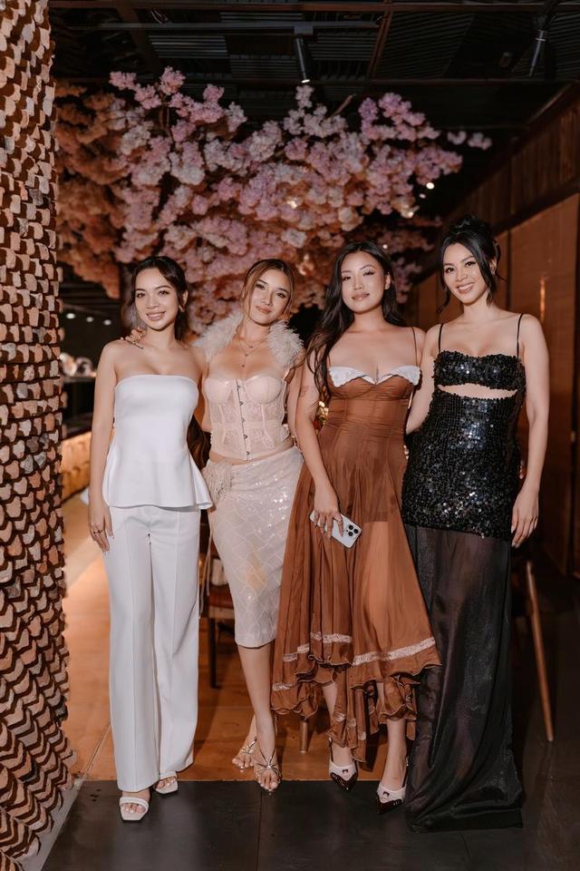 Four guests dressed up under the cherry blossom ceiling at The Sake