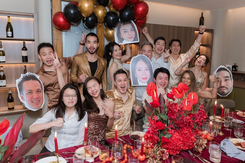 The whole table posing with balloons and big cut-out faces