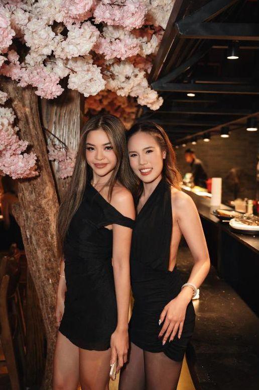 Two guests posing under the cherry blossom tree