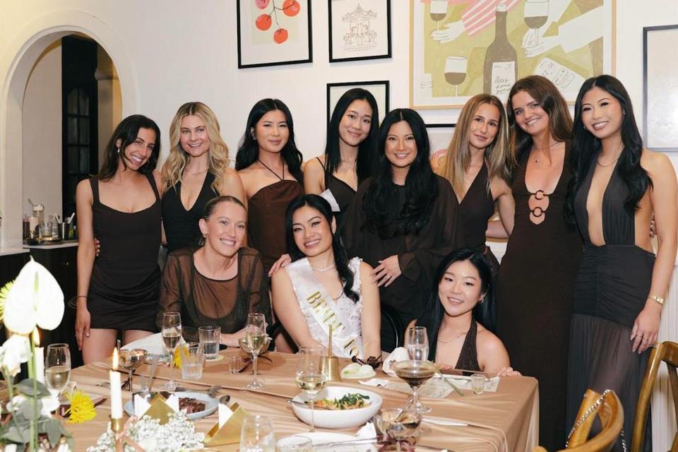 A group of friends posing around the dinner table