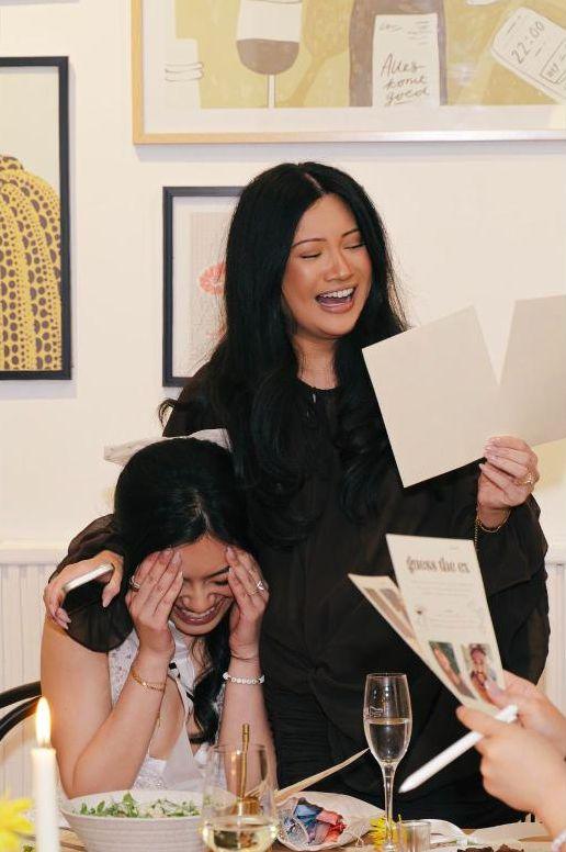 Friends in fits of laughter reading out a party game