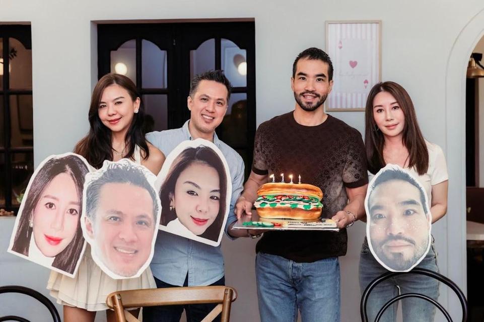 Birthday celebration with a bánh mì cake and giant cut-out faces
